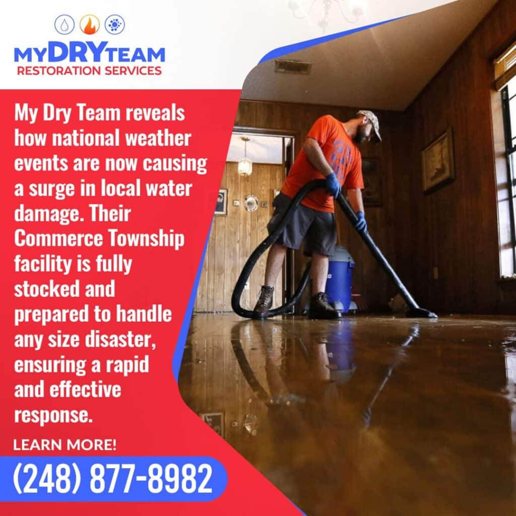 A My Dry Team professional uses a vacuum to remove water from a flooded floor in Commerce Township, MI. Image highlights 24/7 water damage restoration and emergency cleanup services