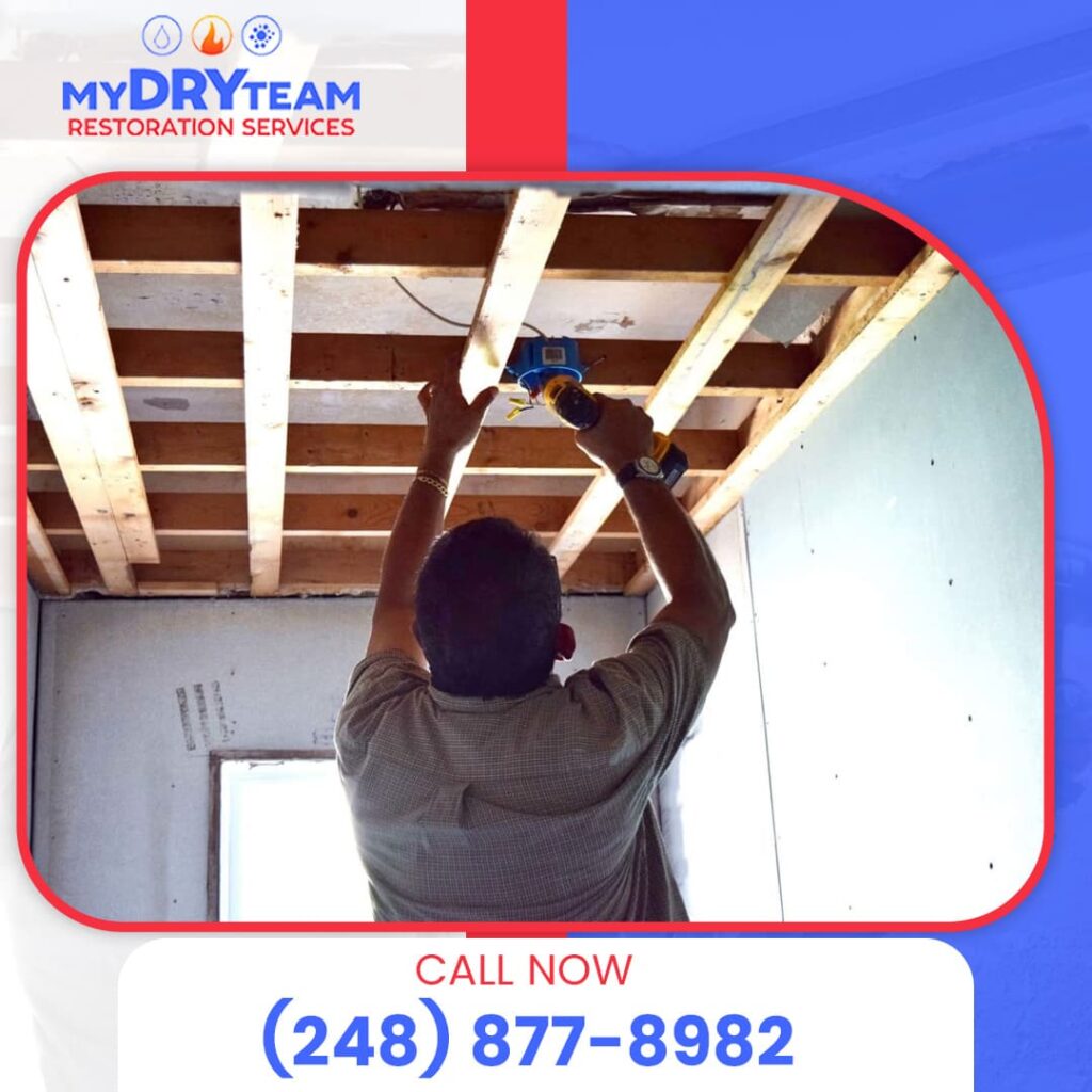 Technician inspecting ceiling for moisture damage